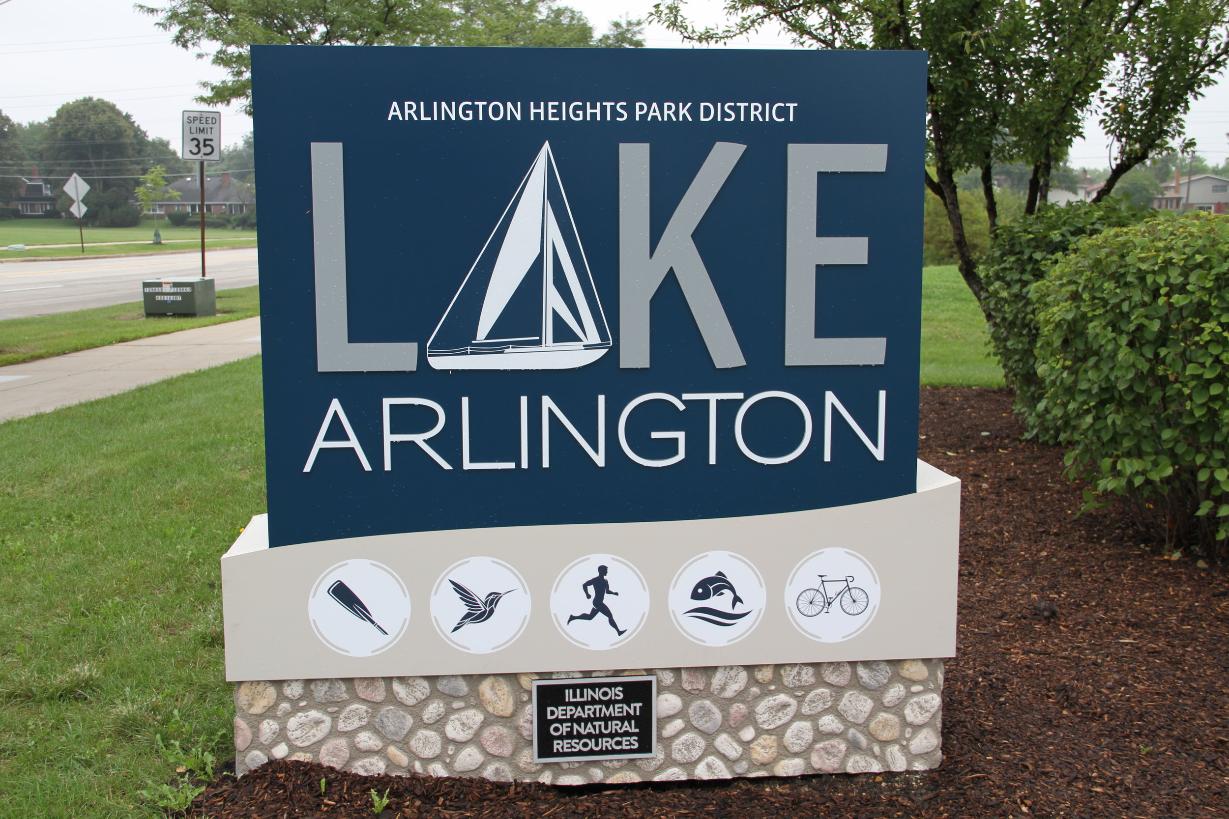 Primary Lake Arlington entrance sign with sailboat logo and activity icons